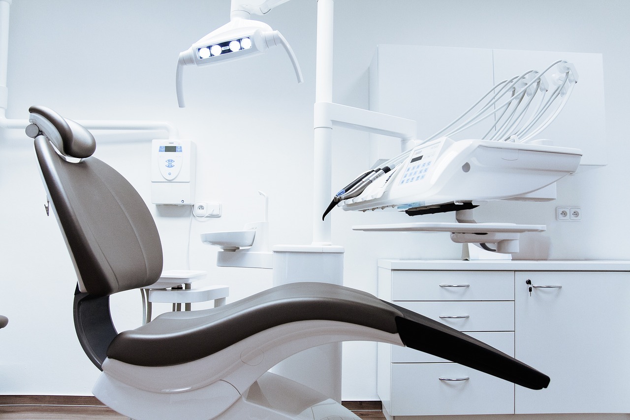 A bright, clean treatment room with a dental chair and instruments ready