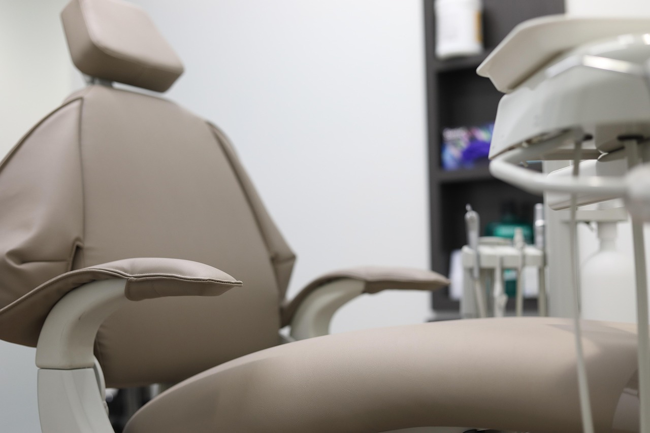 A soft beige dental chair in a calm treatment room